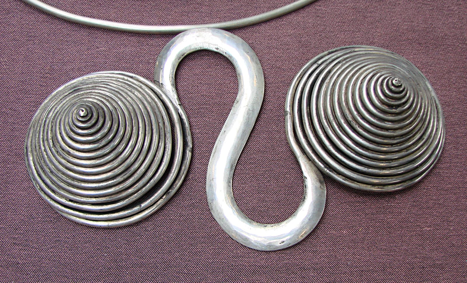 Hmong silver neck ring with a coiled spiral pendant, hammered from heavy silver wire