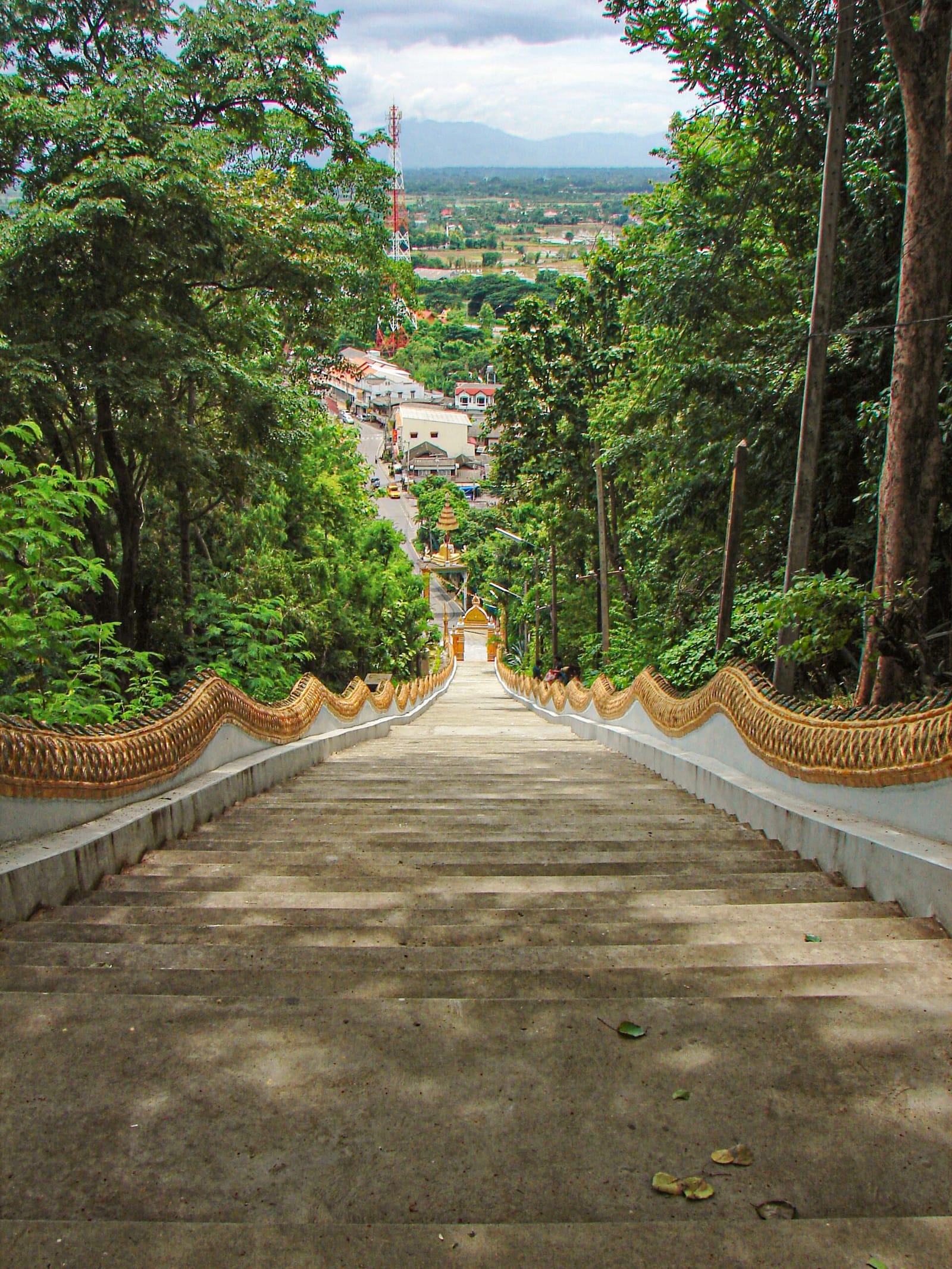 View down the naga staircase over Doi Saket town and the valley plain below the temple